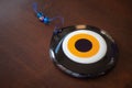 Large glass Turkish evil eye on wooden table