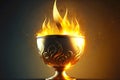 large glossy golden cup with flames on blurred background