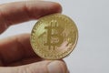 A Large Gold Bitcoin Token in hand Royalty Free Stock Photo