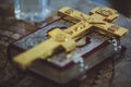 A large gold Orthodox Christian cross is placed on the book. Royalty Free Stock Photo