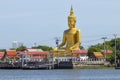 A large golden Buddha image sits along the Chao Phraya River at Wat Bang Chak in Nonthaburi