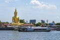 A large golden Buddha image sits along the Chao Phraya River at Wat Bang Chak in Nonthaburi
