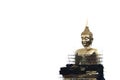 A large golden Buddha image undergoing renovations located outdoors in a Thai temple.  Isolated white background. Royalty Free Stock Photo