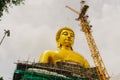 A large golden Buddha statue is under construction, Wat Paknam Bhasicharoen in Phasi Charoen district, Bangkok, Thailand Royalty Free Stock Photo