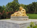Large golden Laughing Buddha. Quinta dos Loridos, Portugal. Royalty Free Stock Photo