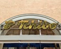 Large golden logo of the Tchibo coffee company above the entrance