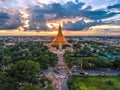 Large golden pagoda Located in the community at sunset , Phra Pa