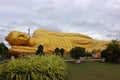 A large golden reclining Buddha in a temple in Songkhla, Thailand. Royalty Free Stock Photo