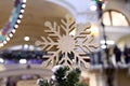 Large golden snowflake on top of a Christmas tree