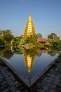 A large golden yellow pagoda at Wat Tha It In Ang Thong Province in Thailand