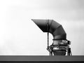 large gooseneck mechanical vent pipe on roof top in monochrome