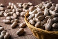 Large grains of peanuts in the shell and basket Royalty Free Stock Photo