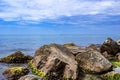 Large granite boulders overgrown with mussels against the background of the sea horizon in Zalizny Port Ukraine. Beautiful Royalty Free Stock Photo