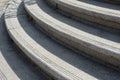 Large granite staircase to a convex arch. the edges of the stairs are roughened by several notches in the stone. protection agains Royalty Free Stock Photo