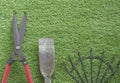 Large grass cutting shears, red handle, steel rake, digging shovel, lawn background Arranged in order