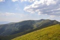 Large grassy meadow, slopes and forested hillsides of Carpathians Royalty Free Stock Photo