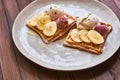 Large gray ceramic plate with fresh Belgian sweet waffles, ice cream, strawberries, bananas and condensed milk. Delicious breakfas Royalty Free Stock Photo