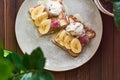 Large gray ceramic plate with fresh Belgian sweet waffles, ice cream, strawberries, bananas and condensed milk. Delicious breakfas Royalty Free Stock Photo