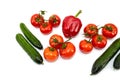 Large green cucumbers, one red bell pepper, red tomatoes on a green branch Royalty Free Stock Photo