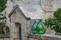 Large green glass wine jars in Matera, Italy