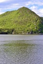 Large green hill casting reflectons onto Bonne Bay at Norris Point