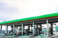 Large green industrial gas station for refueling vehicles, trucks and tanks with fuel, gasoline and diesel in the winter Royalty Free Stock Photo