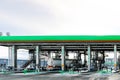 Large green industrial gas station for refueling vehicles, trucks and tanks with fuel, gasoline and diesel in the winter Royalty Free Stock Photo