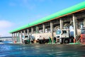 Large green industrial gas station for refueling vehicles, trucks and tanks with fuel, gasoline and diesel in the winter Royalty Free Stock Photo