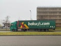 Large green Mercedes-Benz cargo truck driving on the street with trailer signage for Bakugls.com Ireland Europe cargo