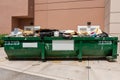 Large green metal dumpster filled with garbage from building renovation - Fort Lauderdale, Florida, USA