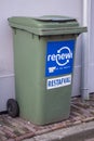 Large green recycling rubbish wheely bin on street