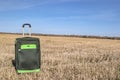 Large green suitcase on wheels Royalty Free Stock Photo