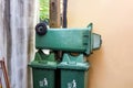 Large green wheelie bin stacked not in use.