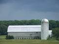 Large grey barn and silo in a field in Vermont