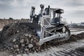 Powerful Heavy-Duty Bulldozer Moving Earth at Construction Site Royalty Free Stock Photo