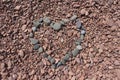 Grey Rocks in the Shape of a Heart on Rose Colored Stones Royalty Free Stock Photo