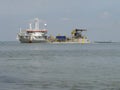 A large grey hopper dredger at the westerschelde in holland