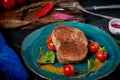 Large grilled beef steak on a plate with cherry tomatoes and mustard in plate