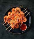 Large grilled prawns on wooden skewers. Shrimp kebabs.