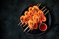 Large grilled prawns on wooden skewers. Shrimp kebabs.