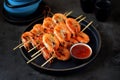 Large grilled prawns on wooden skewers. Shrimp kebabs.