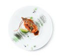 Large grilled tiger shrimp with lime, microgreens and sauce in plate isolated on white background. Healthy seafood, top view Royalty Free Stock Photo