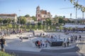 A large group of children and teenagers ride skateboards