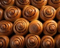 a large group of cinnamon buns on a black background