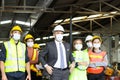 Large group of confident industrial engineer worker and foreman boss with face mask wearing safety equipment standing at