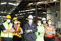 Large group of confident industrial engineer worker and foreman boss with face mask wearing safety equipment standing with arms