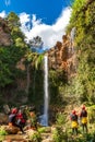 Large group enjoy waterfall descent using ropes