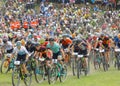 Large group of fighting mountainbike cyclists cycling uphill