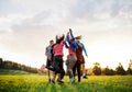 Large group of fit and active people jumping after doing exercise in nature. Royalty Free Stock Photo