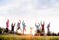 Large group of fit and active people jumping after doing exercise in nature. Royalty Free Stock Photo